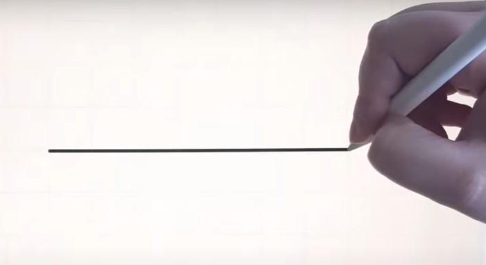 Someone creating a perfectly straight line on an iPad with an Apple Pencil in Procreate