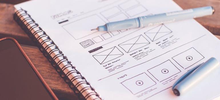 a notebook with website design draft